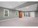Finished basement offers extra living space with carpeted floors, built-in shelving, and natural light from windows at 501 Avery Creek Pointe, Woodstock, GA 30188
