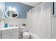 Nautical-themed bathroom with blue striped wallpaper, bathtub with shower and white vanity at 501 Avery Creek Pointe, Woodstock, GA 30188