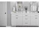 Bathroom featuring double sink vanity with white cabinets, quartz countertops and modern fixtures at 501 Avery Creek Pointe, Woodstock, GA 30188