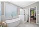 Modern bathroom with freestanding tub, glass-enclosed shower, and elegant marble accents at 501 Avery Creek Pointe, Woodstock, GA 30188