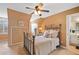 Inviting bedroom boasts neutral paint, a ceiling fan, built-in storage, and an en-suite bathroom at 501 Avery Creek Pointe, Woodstock, GA 30188