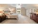 Cozy bedroom features neutral paint, a ceiling fan, carpeted floors, and natural light from a large window at 501 Avery Creek Pointe, Woodstock, GA 30188