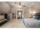 Cozy bedroom features a ceiling fan, neutral paint, a built-in desk, and natural light from a large window at 501 Avery Creek Pointe, Woodstock, GA 30188