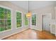 Bright dining area with hardwood floors and large windows providing backyard view at 501 Avery Creek Pointe, Woodstock, GA 30188