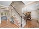 Open foyer with hardwood floors, a staircase, and views of the dining room and living room creates a welcoming space at 501 Avery Creek Pointe, Woodstock, GA 30188