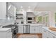 Stylish kitchen features stainless steel appliances, white cabinets, and an open design at 501 Avery Creek Pointe, Woodstock, GA 30188