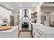 Bright kitchen features white cabinetry, stainless steel appliances, hardwood floors and a farmhouse sink at 501 Avery Creek Pointe, Woodstock, GA 30188