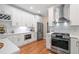 Well-equipped kitchen with white cabinets, stainless appliances, and hardwood floors at 501 Avery Creek Pointe, Woodstock, GA 30188
