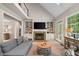 Cozy living room boasts a fireplace, built-in shelving, and French doors at 501 Avery Creek Pointe, Woodstock, GA 30188