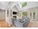 Bright living room with vaulted ceilings, a stone fireplace, and large windows offers a cozy and inviting atmosphere at 501 Avery Creek Pointe, Woodstock, GA 30188
