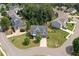 Aerial view of a two-story home nestled in a neighborhood with mature trees and well-kept landscaping at 115 Greenbrier Way, Canton, GA 30114