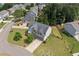 Aerial view of the charming two-story home with a well-maintained lawn, mature trees, and a fenced backyard at 115 Greenbrier Way, Canton, GA 30114
