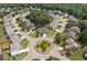 Aerial view of a residential neighborhood with well-maintained homes, mature trees, and circular streets at 115 Greenbrier Way, Canton, GA 30114