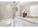 Bathroom with double sink vanity with granite countertop, decorative accents and tiled shower at 115 Greenbrier Way, Canton, GA 30114