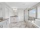 Expansive bathroom with granite counters, white cabinets, large tub, and a glass enclosed shower at 115 Greenbrier Way, Canton, GA 30114