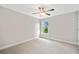 An airy bedroom featuring neutral walls, carpet, a ceiling fan, and a bright window at 115 Greenbrier Way, Canton, GA 30114