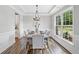 Bright dining room featuring a modern chandelier, beautiful floors and large window at 115 Greenbrier Way, Canton, GA 30114