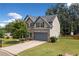 Beautiful two-story home featuring a stone facade, neutral siding, mature landscaping, and a two-car garage at 115 Greenbrier Way, Canton, GA 30114