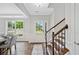 Inviting foyer featuring wood floors, staircase, decorative rug, and lots of natural light at 115 Greenbrier Way, Canton, GA 30114
