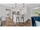 Modern kitchen features granite countertops, stainless steel appliances, white cabinetry and dark hardwood floors at 115 Greenbrier Way, Canton, GA 30114