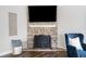 Close-up of the stone fireplace and comfortable seating, a cozy gathering place at 115 Greenbrier Way, Canton, GA 30114
