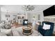 Open-concept living room with a stone fireplace and a view of the dining and kitchen areas at 115 Greenbrier Way, Canton, GA 30114