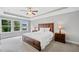 Main bedroom featuring a tray ceiling, plush carpet, and a large window with a green view at 115 Greenbrier Way, Canton, GA 30114