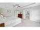 Main bedroom with trey ceilings featuring a dresser with a view of the bathroom and the hallway at 115 Greenbrier Way, Canton, GA 30114