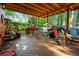 Spacious back porch with wooden floors and multiple seating areas at 1776 Fairway Hill Se Dr, Atlanta, GA 30317