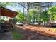 Overgrown backyard featuring an assortment of cars and junked materials at 1776 Fairway Hill Se Dr, Atlanta, GA 30317