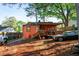 View of home's backyard featuring a covered porch, wood deck, and mature trees at 1776 Fairway Hill Se Dr, Atlanta, GA 30317