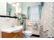 Traditional bathroom with white tile, updated fixtures, and blue accents at 1776 Fairway Hill Se Dr, Atlanta, GA 30317