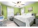Bedroom featuring a large bed, gray walls and carpet, and a comfortable recliner at 1776 Fairway Hill Se Dr, Atlanta, GA 30317