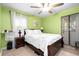 Bedroom features white bedding, a dark wood bed frame, and green walls at 1776 Fairway Hill Se Dr, Atlanta, GA 30317