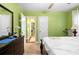 Bedroom with green walls and a view through an open doorway at 1776 Fairway Hill Se Dr, Atlanta, GA 30317