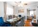 Formal dining room with elegant chairs, a modern chandelier, and hardwood floors at 1776 Fairway Hill Se Dr, Atlanta, GA 30317