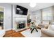 Inviting living room with a fireplace, hardwood floors, and plenty of natural light at 1776 Fairway Hill Se Dr, Atlanta, GA 30317
