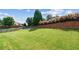 Expansive backyard featuring lush lawn, privacy fence, and mature trees at 3024 Bridgehaven Ct, Snellville, GA 30039
