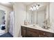 Bathroom with white vanity, framed mirror and adjacent shower/tub combo at 3024 Bridgehaven Ct, Snellville, GA 30039