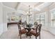 Bright dining area with decorative chandelier, large windows and a view into the game room at 3024 Bridgehaven Ct, Snellville, GA 30039