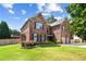 Traditional two-story brick home with manicured landscaping and attached two-car garage at 3024 Bridgehaven Ct, Snellville, GA 30039