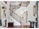 Grand foyer showcasing a staircase with decorative wrought iron spindles and hardwood flooring at 3024 Bridgehaven Ct, Snellville, GA 30039