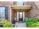 Charming front porch with seating, mature landscaping, and a welcoming entrance at 3024 Bridgehaven Ct, Snellville, GA 30039