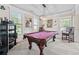 Recreational game room featuring a pool table, large windows, and stylish decor for entertainment at 3024 Bridgehaven Ct, Snellville, GA 30039