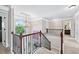 Bright upstairs hallway with decorative railing and natural light from arched window at 3024 Bridgehaven Ct, Snellville, GA 30039