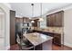 Well-appointed kitchen with an island, modern appliances, and dark wood cabinets at 3024 Bridgehaven Ct, Snellville, GA 30039
