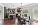 Open kitchen with granite island, dark wood cabinets, and adjacent breakfast nook at 3024 Bridgehaven Ct, Snellville, GA 30039