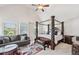 Spacious main bedroom with four-poster bed and comfortable seating area at 3024 Bridgehaven Ct, Snellville, GA 30039