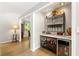 Stylish home bar featuring a wine cooler, granite countertop and wrought iron details at 4290 Inverness Ne Ct, Roswell, GA 30075