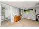 Basement area featuring carpet, a window providing natural light, and access to additional rooms at 4290 Inverness Ne Ct, Roswell, GA 30075